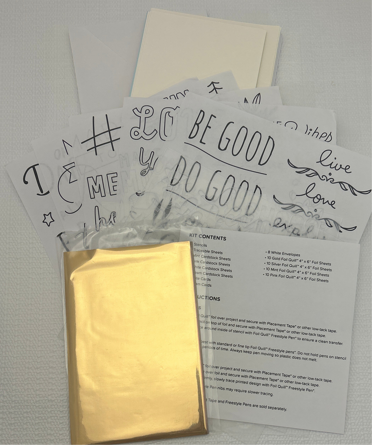 Packaging with gold fabric, white cards with text, and a paper with content details on a gray background.