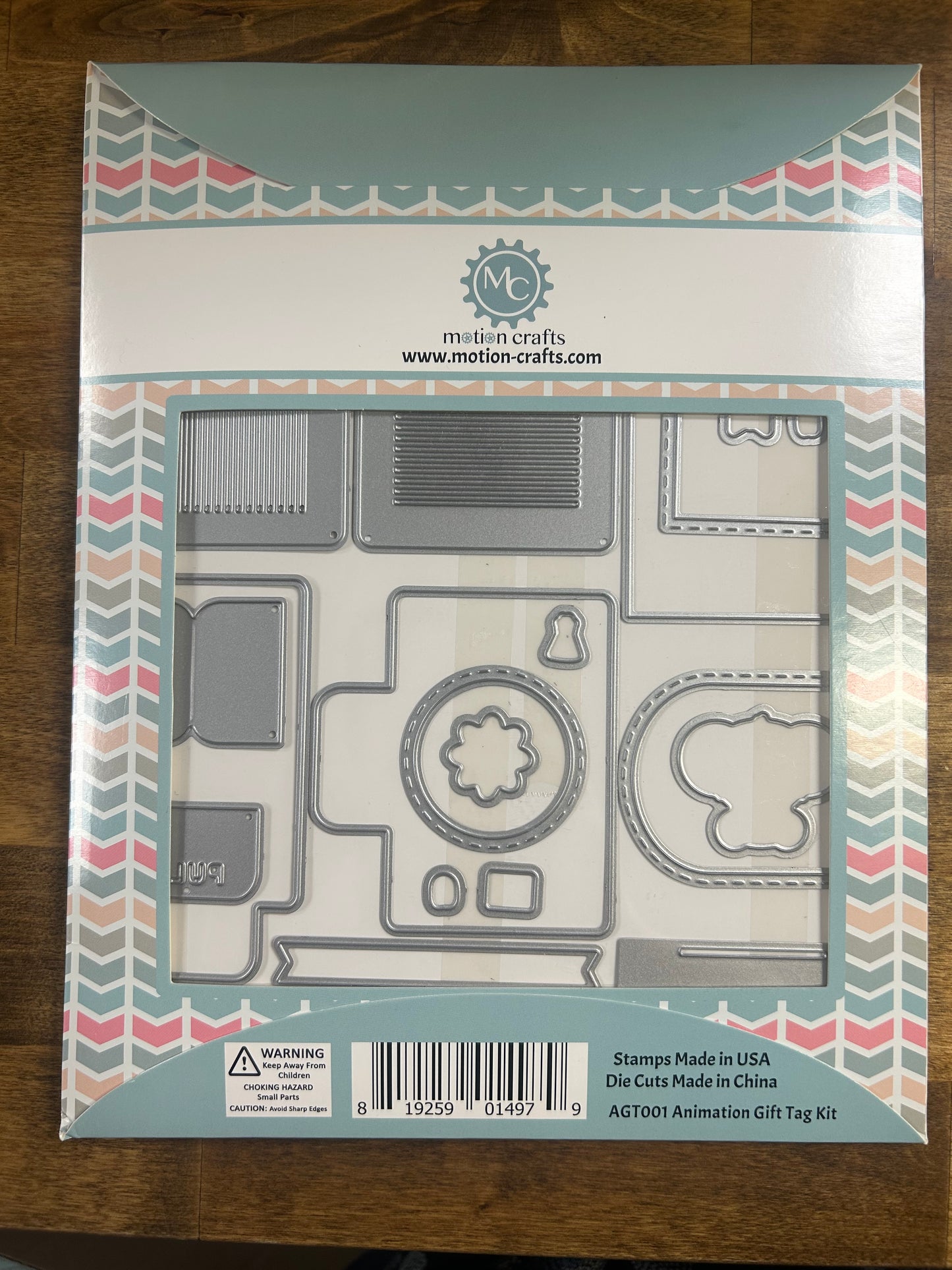 Packaging of a die-cutting set with geometric shapes on a wooden surface