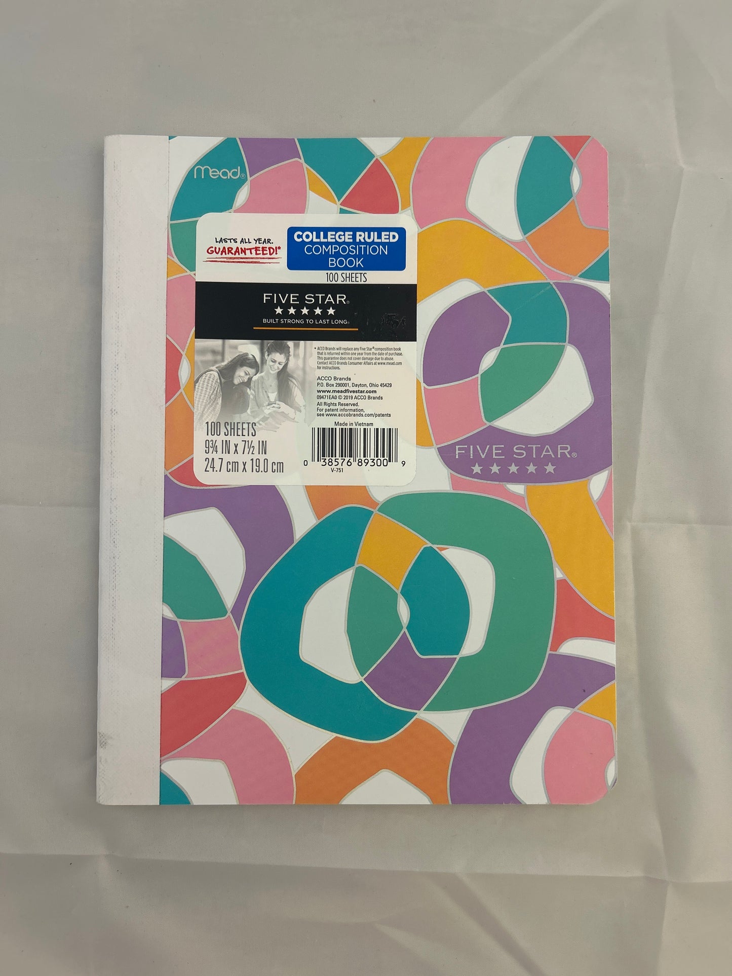 Colorful notebook with geometric pattern on a plain background
