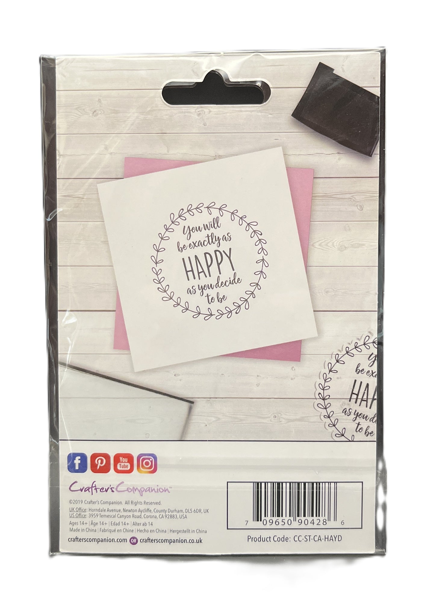 Packaged product with a card and envelope on a wooden surface