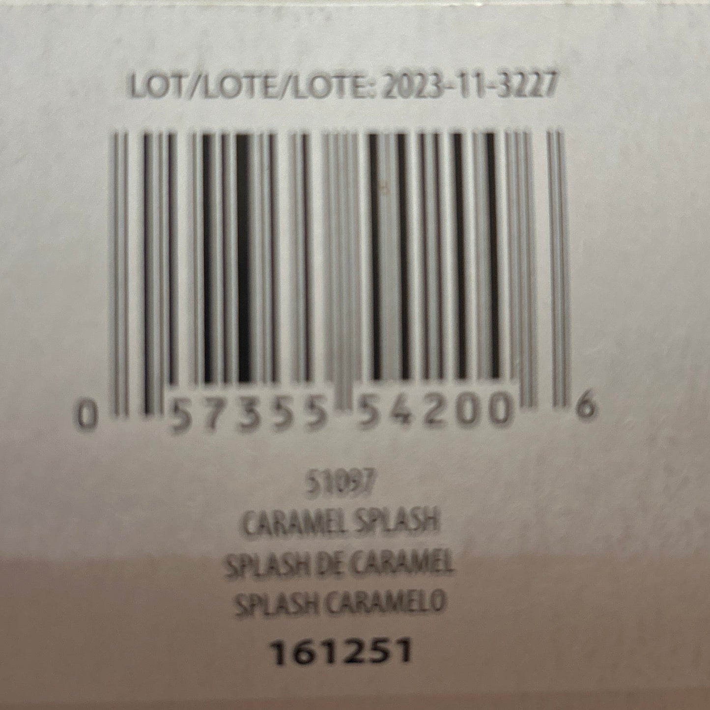 Close-up of a product label with text and barcodes on a blurred background