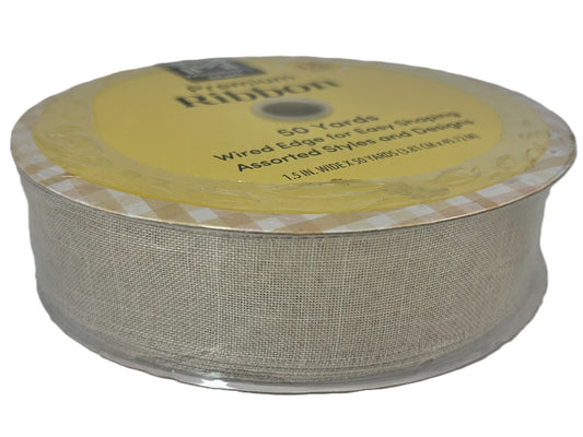 Spool of beige ribbon with a yellow label on a white background