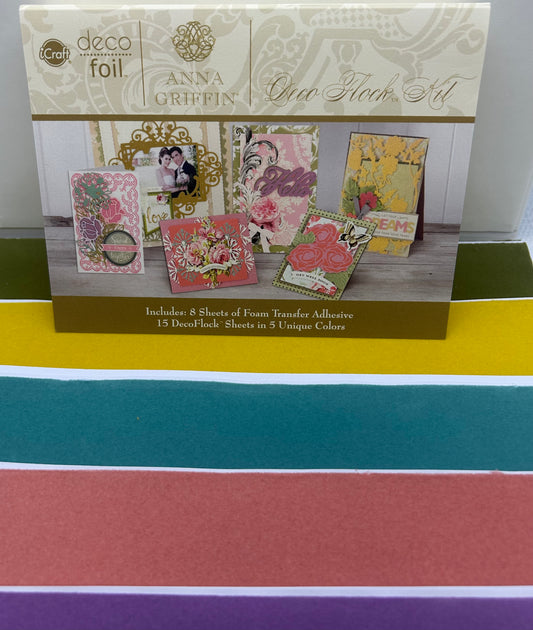 Box of Anna Griffin Deco Foil craft kit on a colorful striped background
