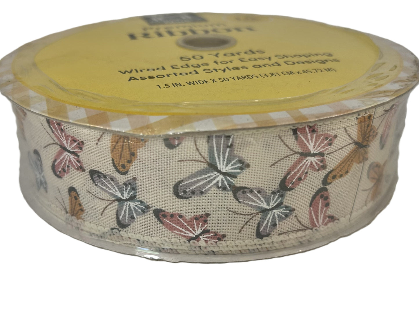 Roll of ribbon with butterfly pattern on a white background
