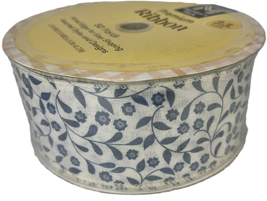 Spool of floral ribbon with a yellow label on a white background