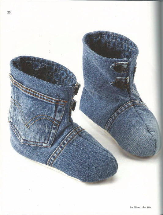 Pair of denim baby booties on a white background