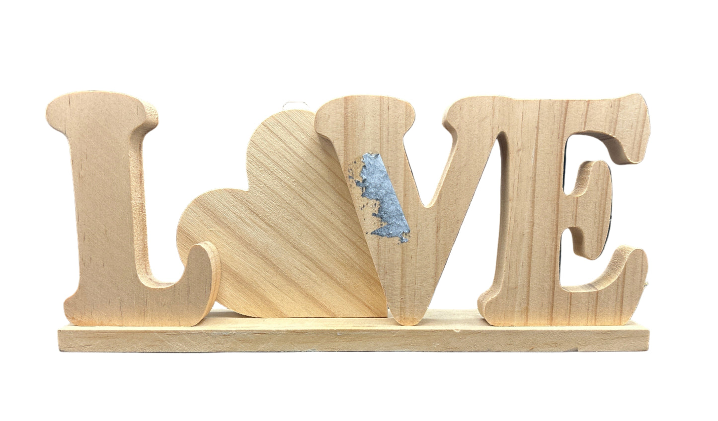 Wooden letters spelling 'LOVE' on a dark blue background