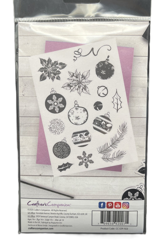 Packaged set of Christmas-themed stamps with decorative elements on a white background.