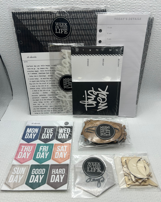 Collection of planner accessories including a weekly planner, stickers, and other small items on a white surface.