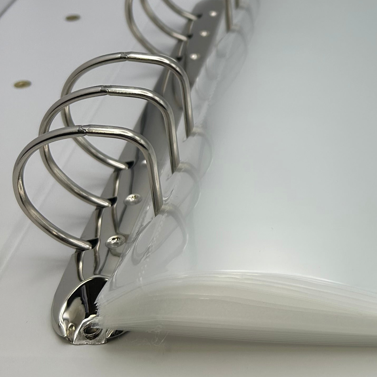 Close-up of a white notebook with metal rings on a white background