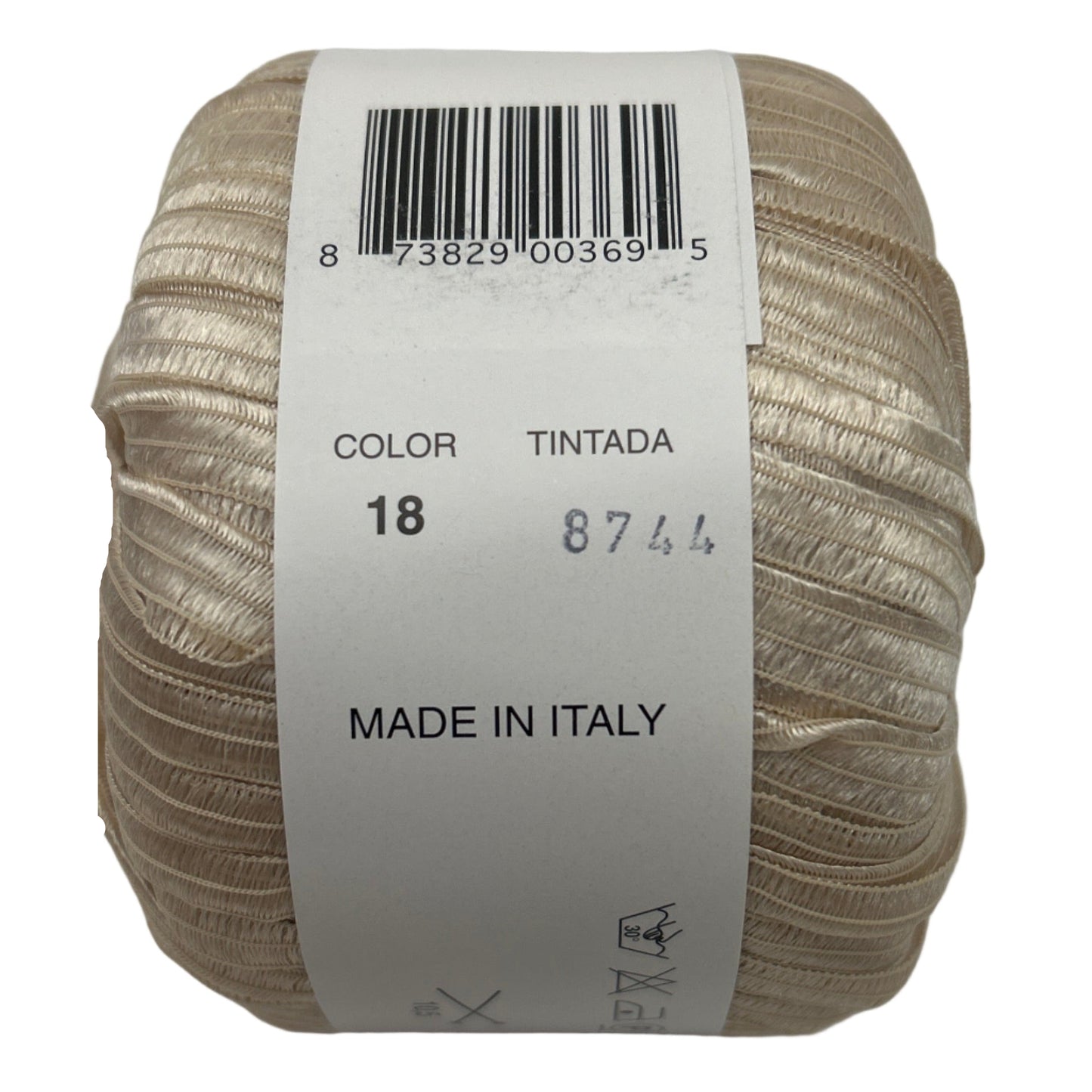 Ball of yarn with a label showing color, brand, and origin on a white background