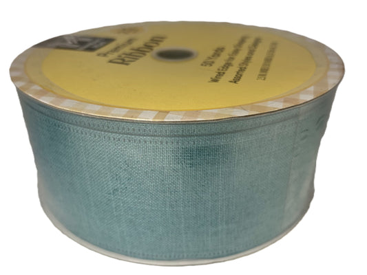 Spool of blue ribbon with a yellow label on a white background