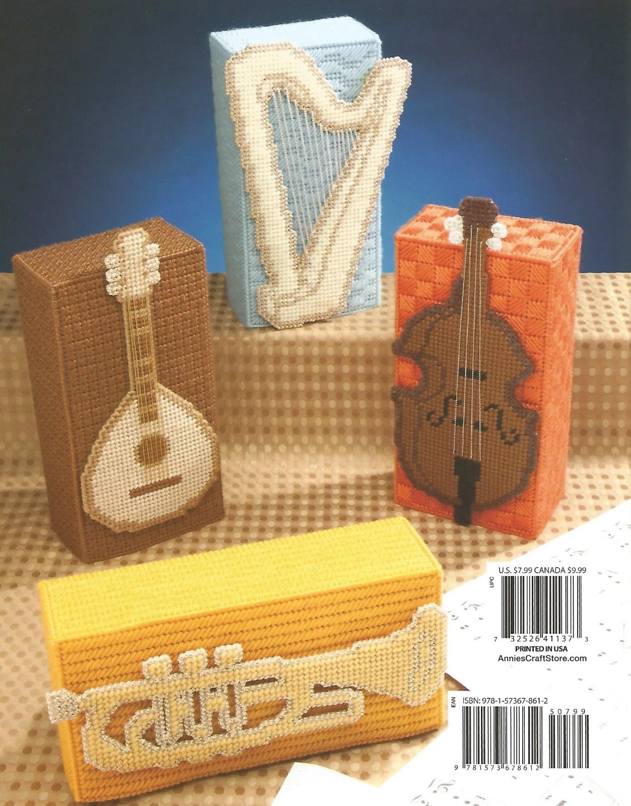 Decorative boxes with musical instrument designs on a textured surface.