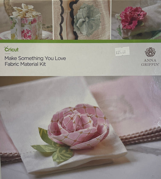 Cricut fabric material kit packaging with floral designs and branding.