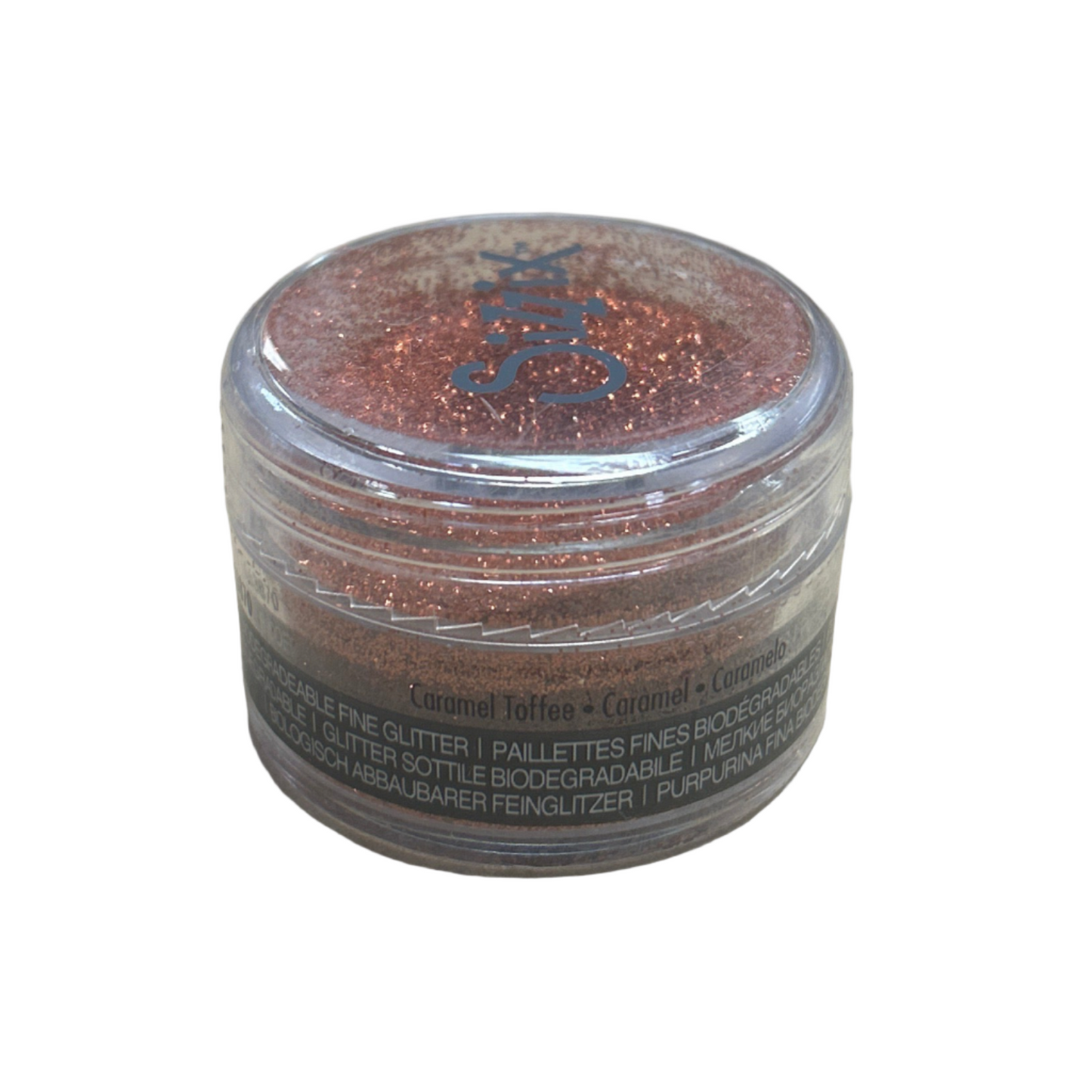 Small container of glitter on a beige surface