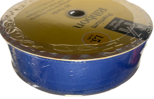 Spool of blue ribbon with gold packaging on a white background