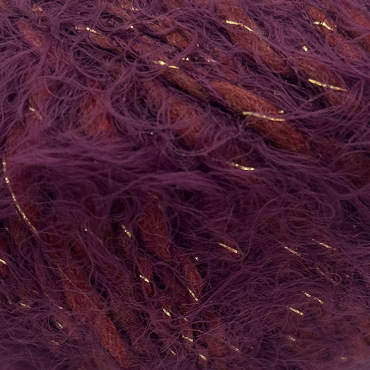 Purple yarn ball with gold threads on a white background