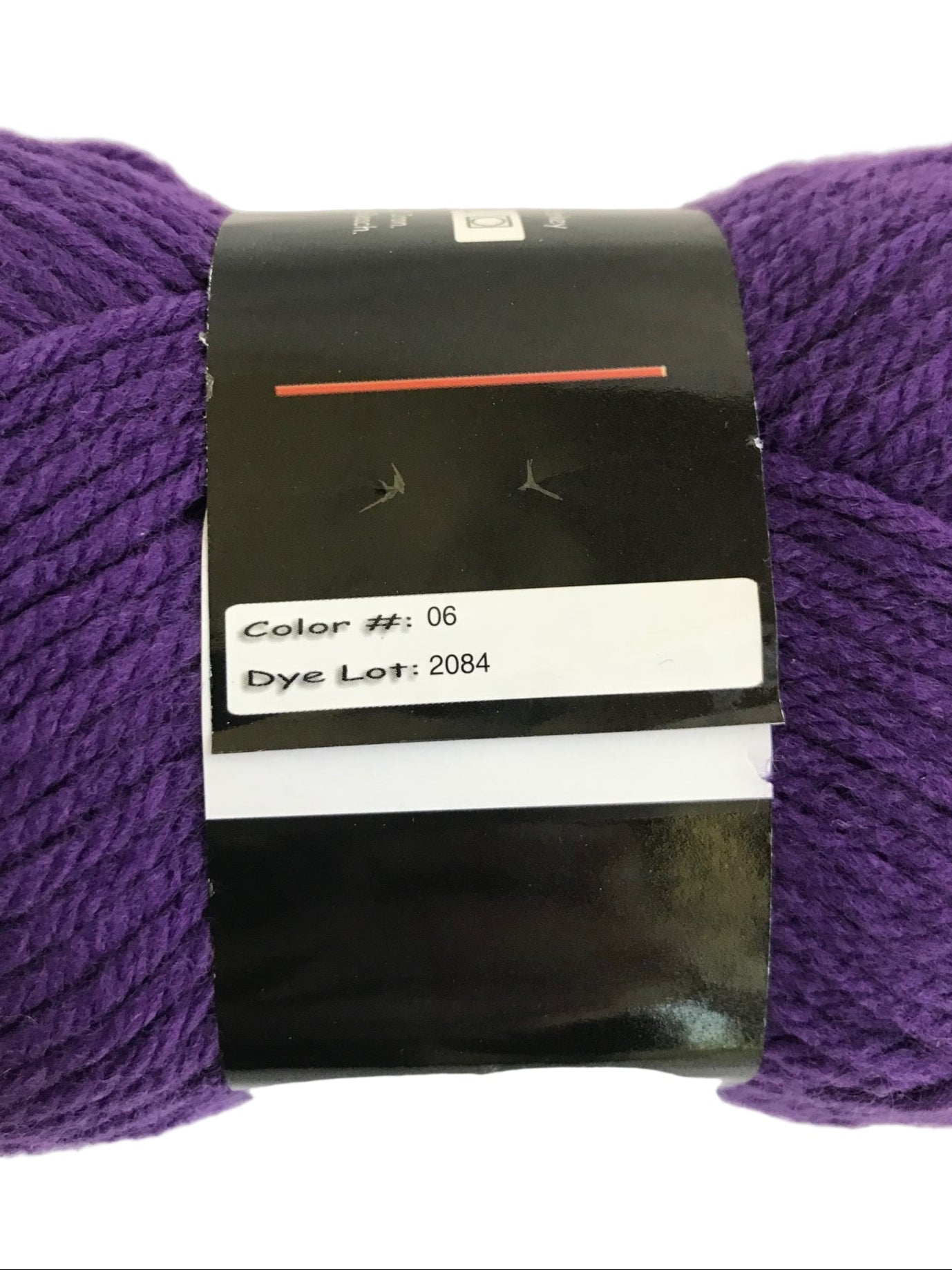 Purple yarn with a label showing color code and dye lot number.