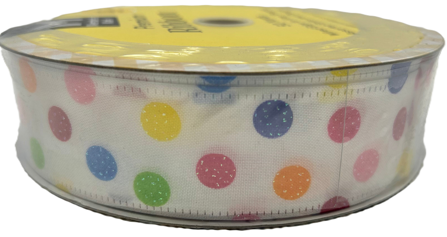 Roll of ribbon with colorful polka dots on a white background