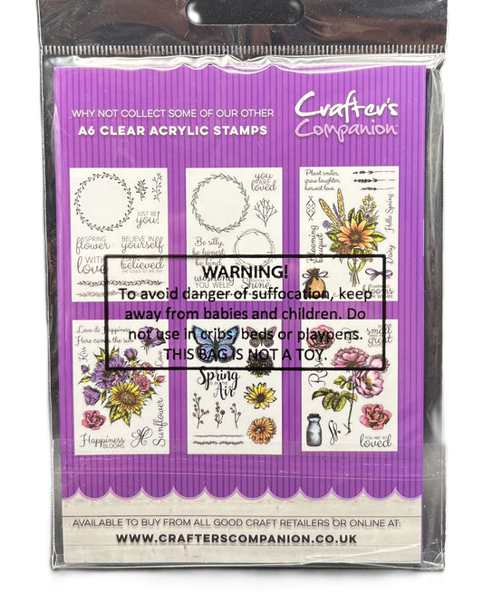 Packaging of Crafter's Companion clear acrylic stamps with a purple border and floral designs.