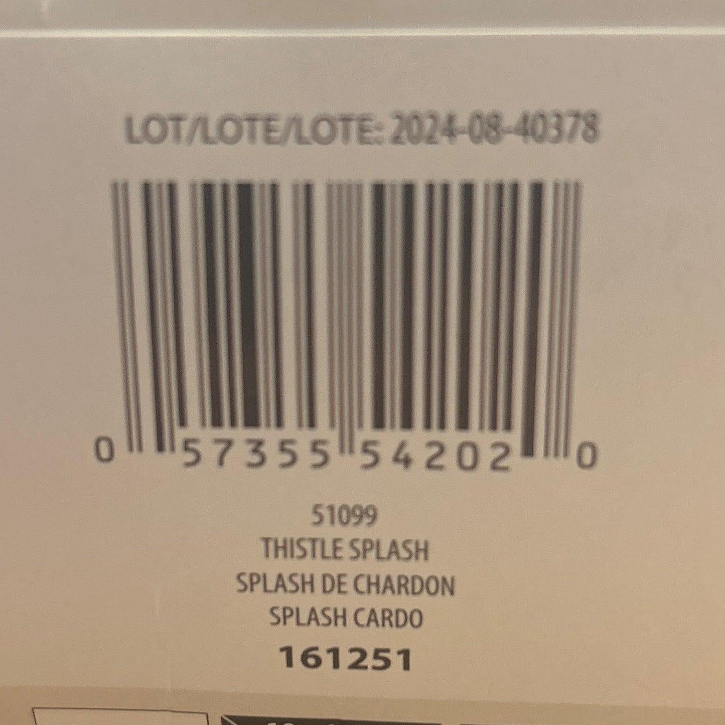 Close-up of a product label with text and a barcode on a wooden surface