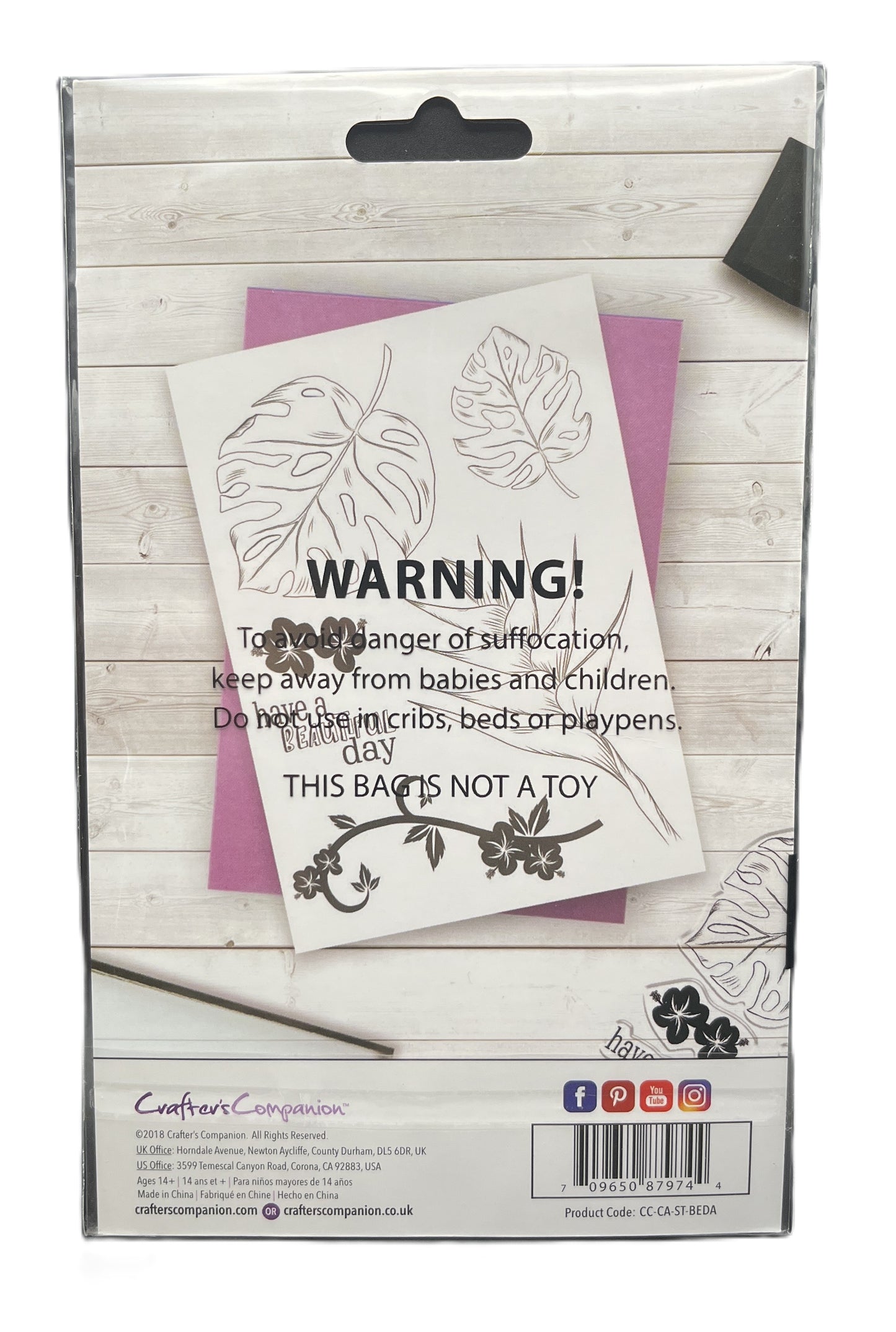Product packaging with warning label and floral design on a wooden surface