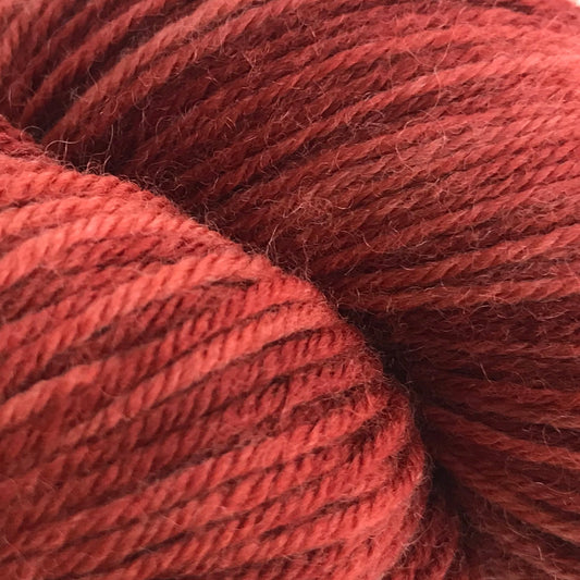 Red skein of yarn on a white background