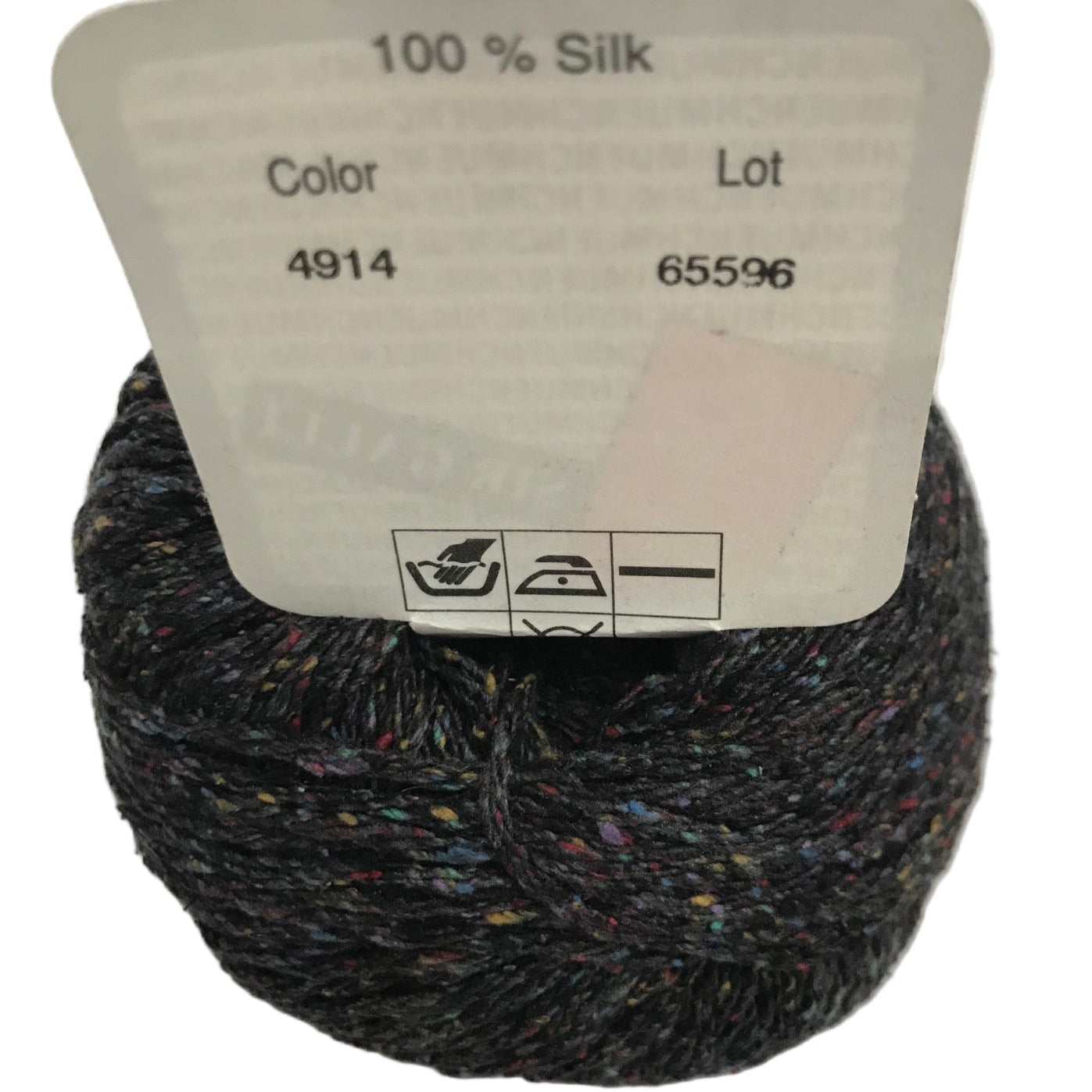 Ball of yarn with a label indicating 100% silk, color 4914, and lot number 65596.