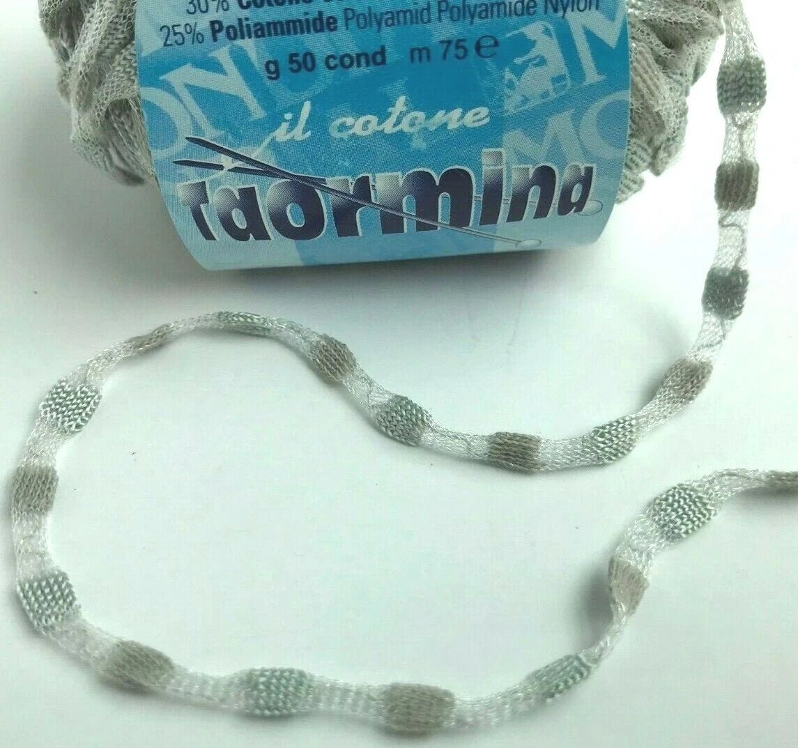 Gray yarn with a blue label on a white background