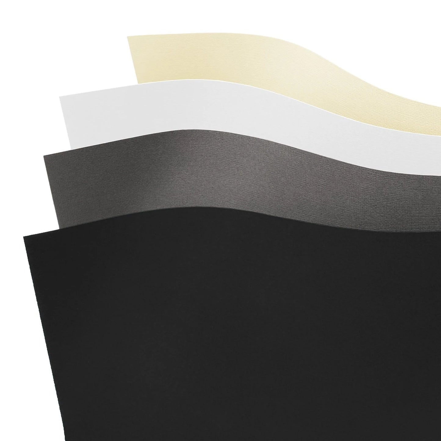 Four sheets of different colored paper (black, gray, white, beige) on a white background.