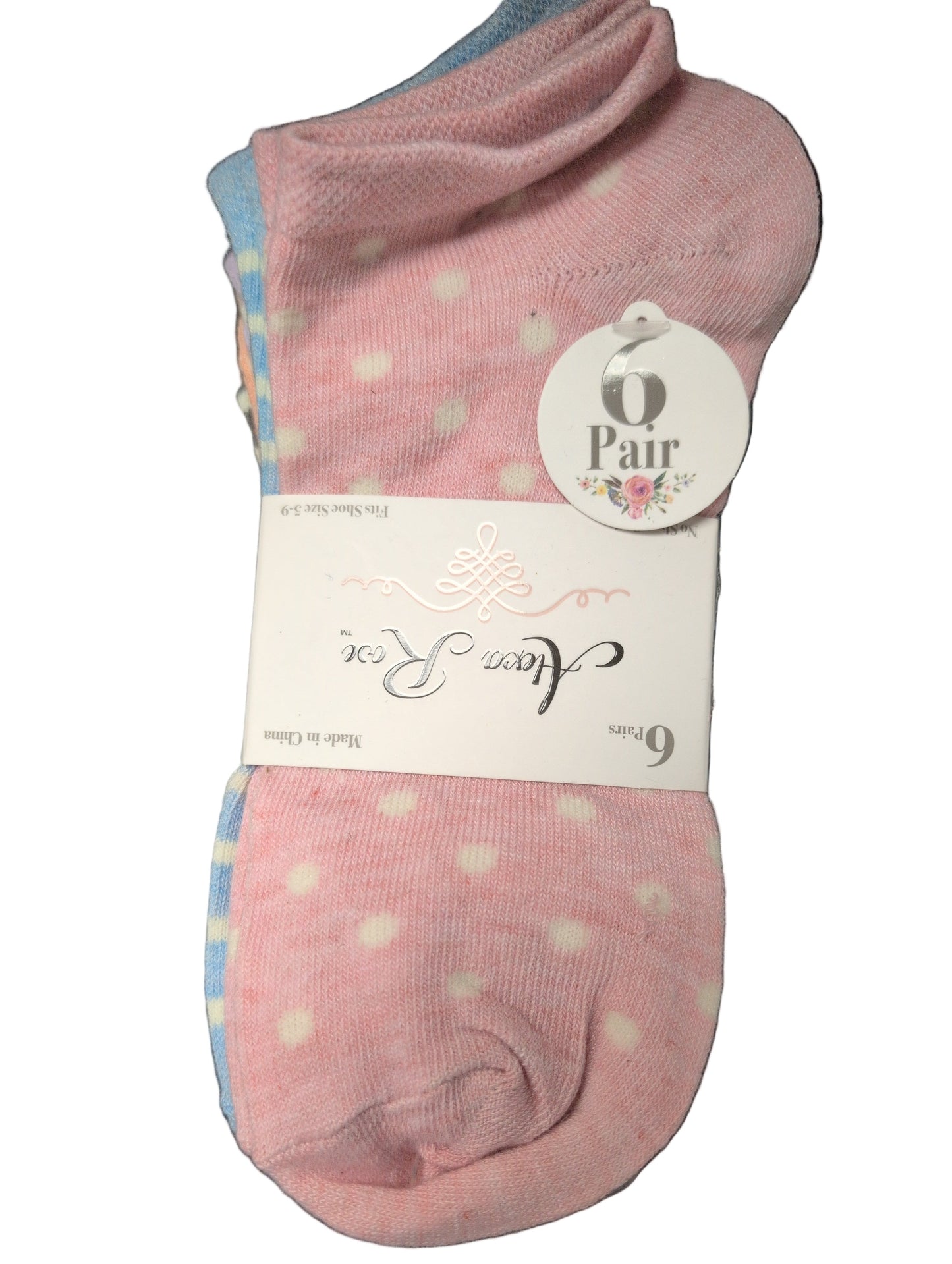 Pink socks with white polka dots in packaging on a white background