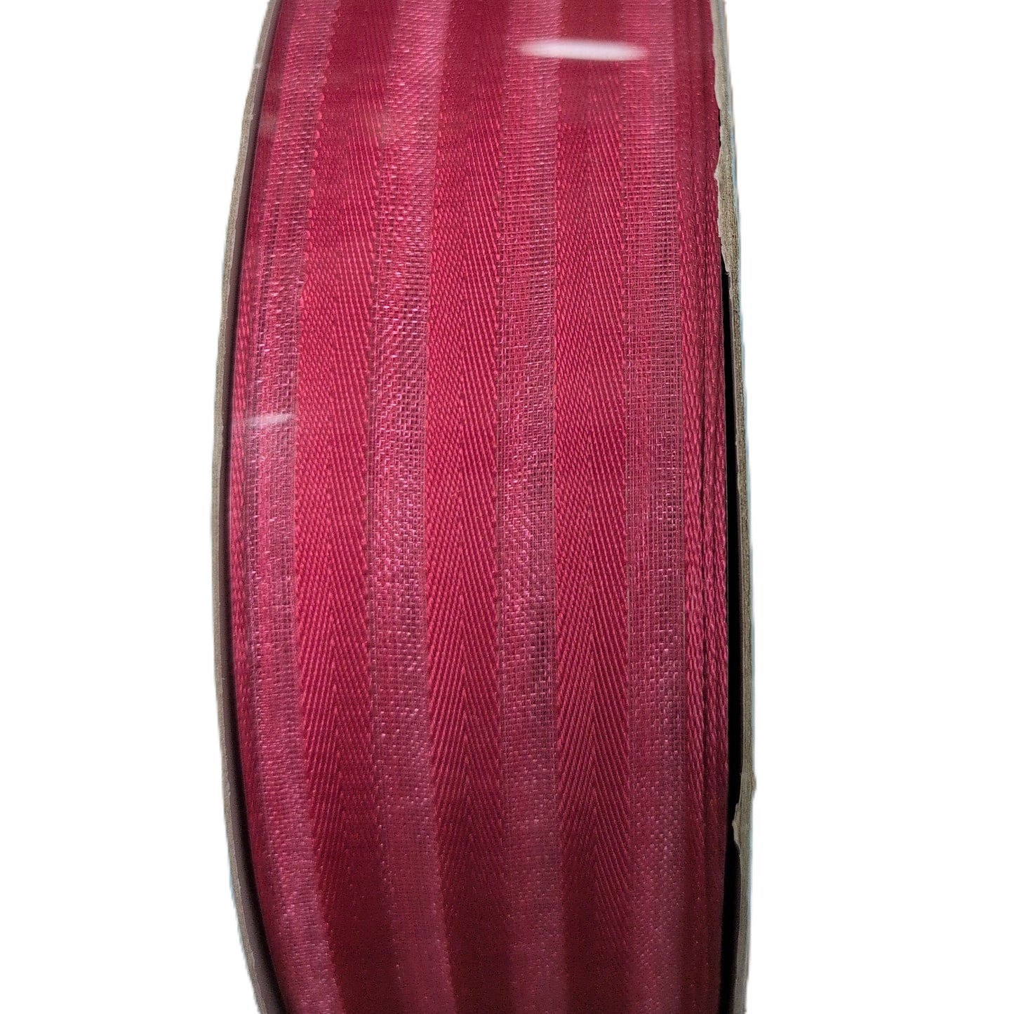 Spool of red ribbon on a white background