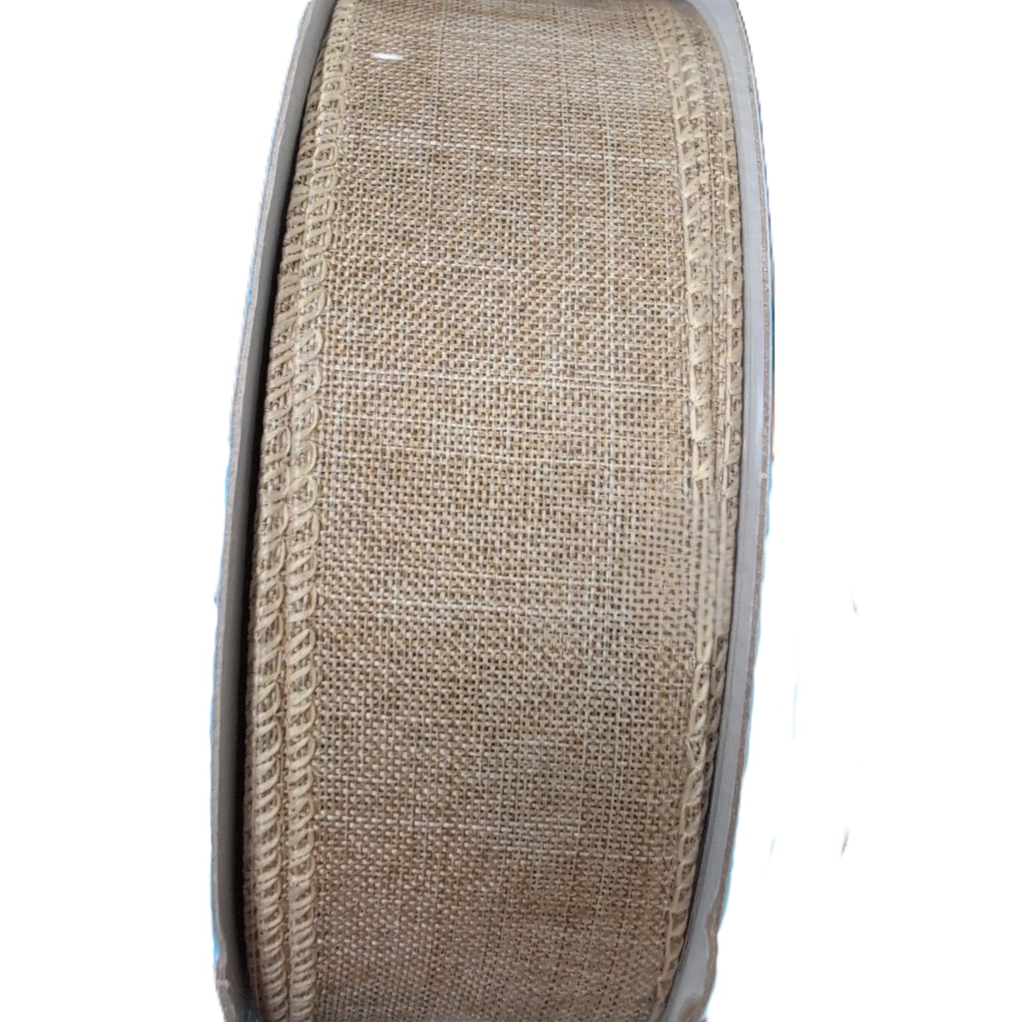 Spool of beige burlap ribbon on a white background
