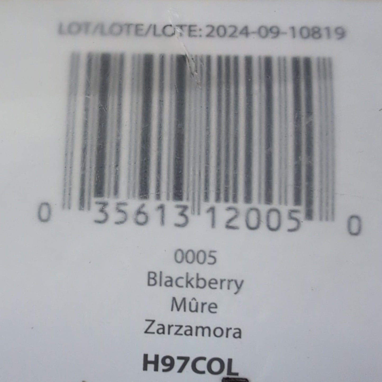 Close-up of a product label with a barcode on a wooden surface