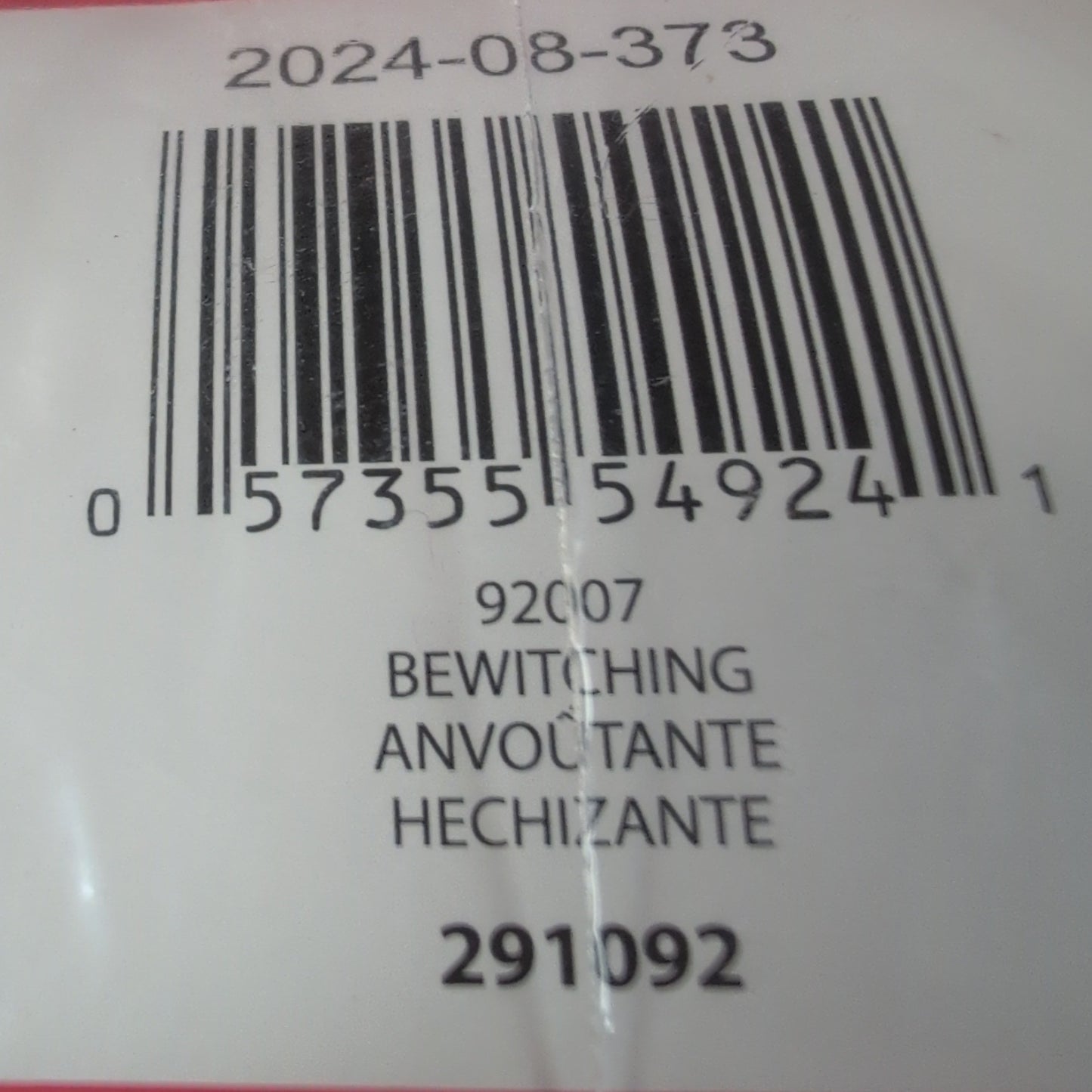 Close-up of a product label with a barcode and text on a red background