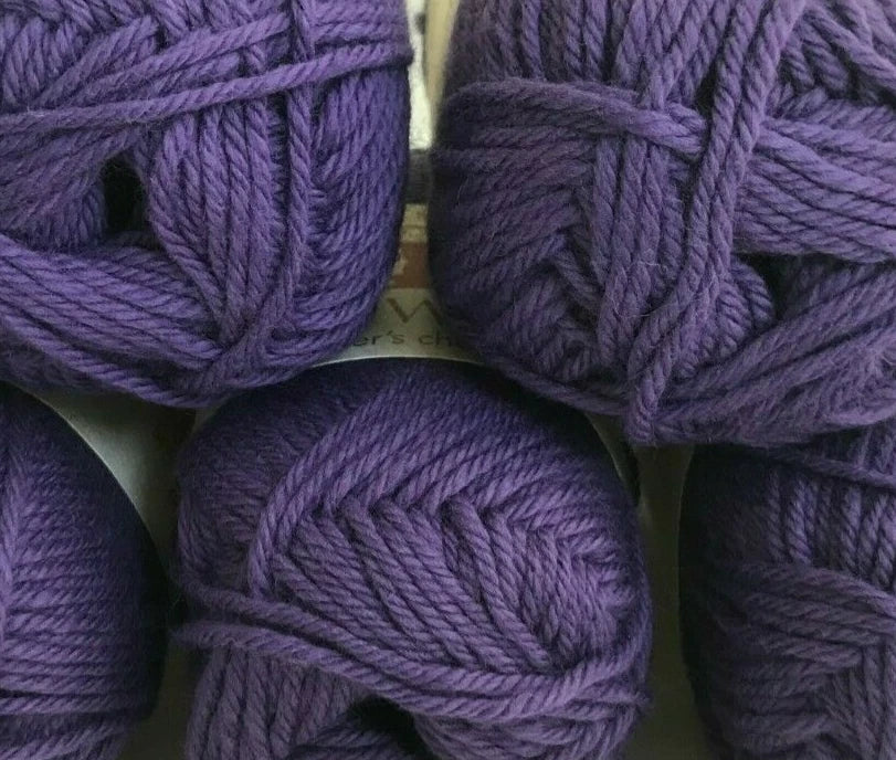 Close-up of purple yarn balls on a white background