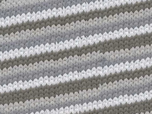 Close-up of a textured fabric with wavy pattern in gray and white.