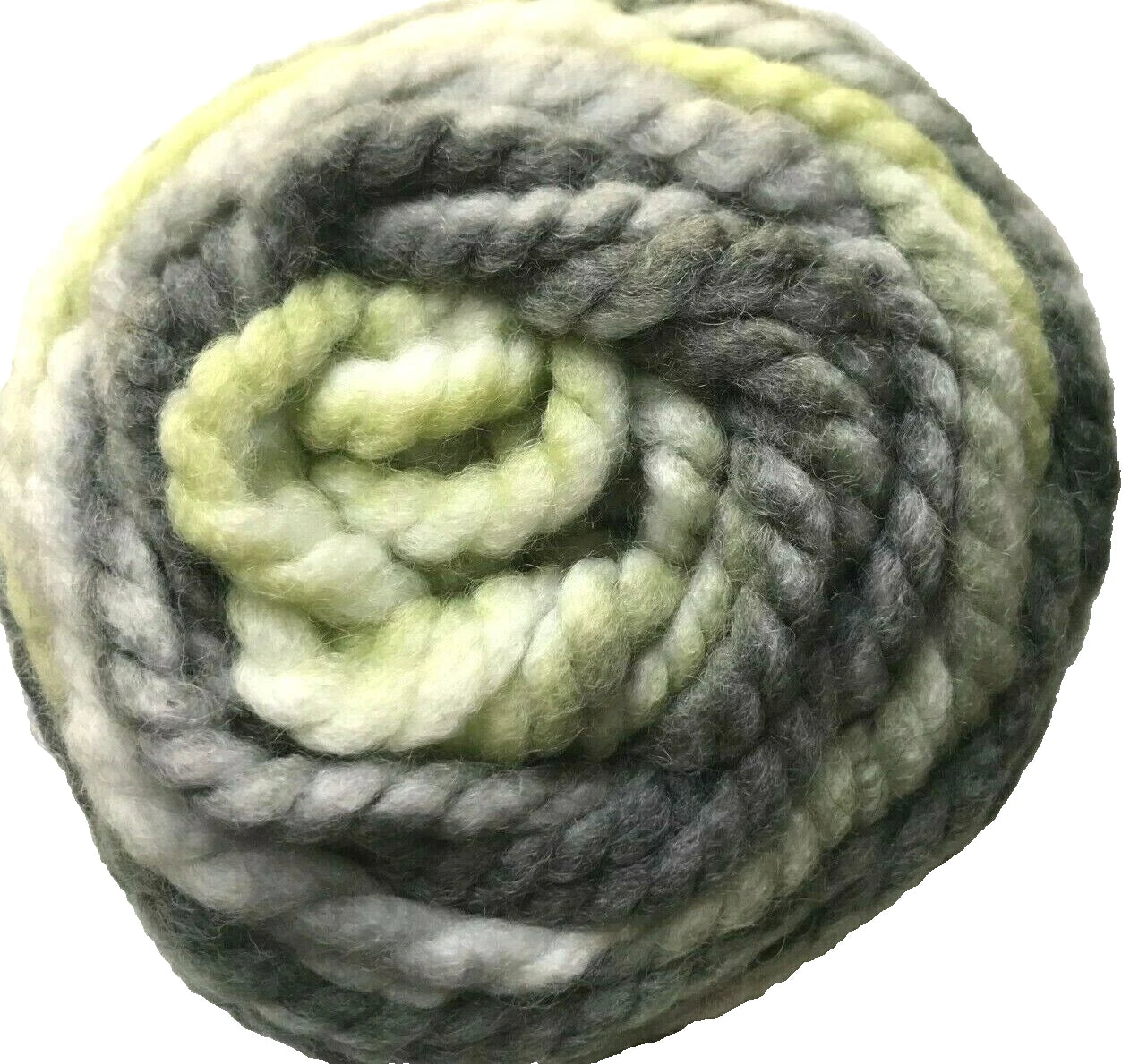 Coiled ball of green and gray yarn on a white background