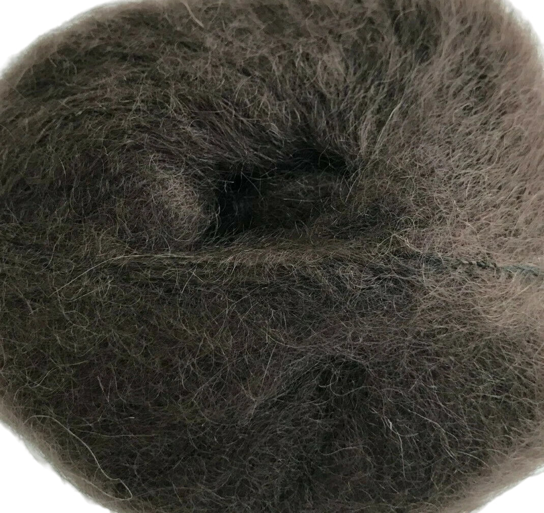 Close-up of a ball of dark brown yarn on a white background