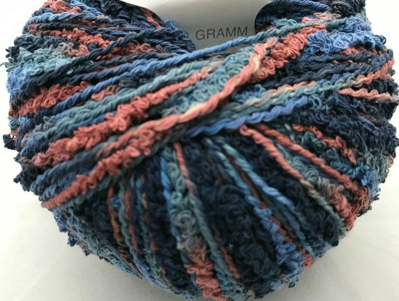 Multicolored yarn ball with blue and pink tones on a white background