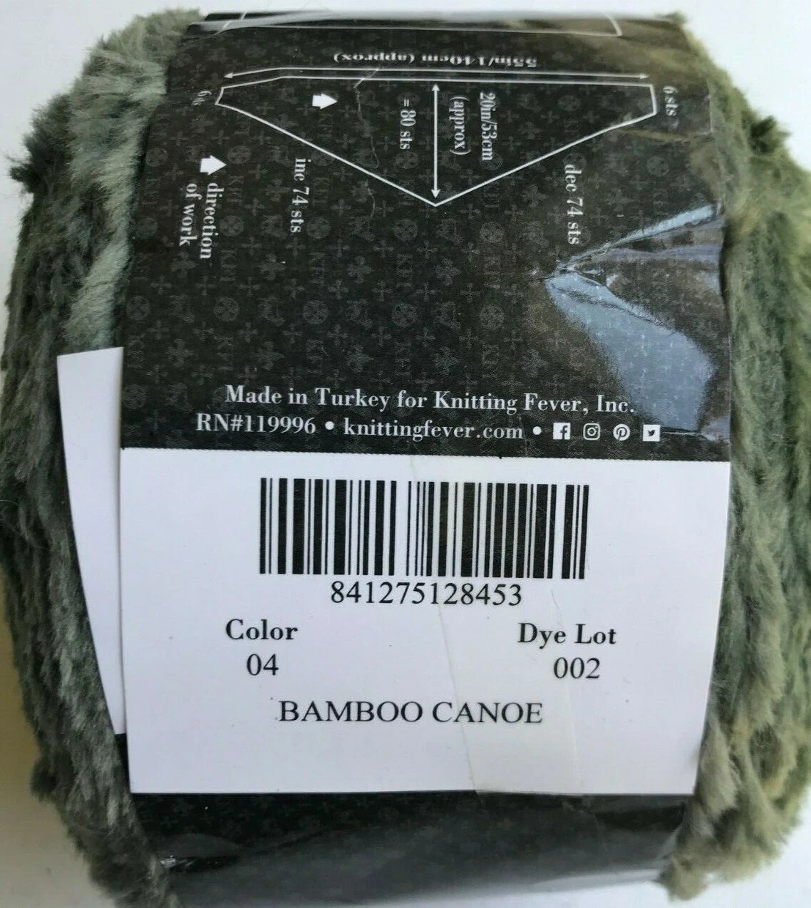 Ball of yarn with a label showing knitting instructions and product details.