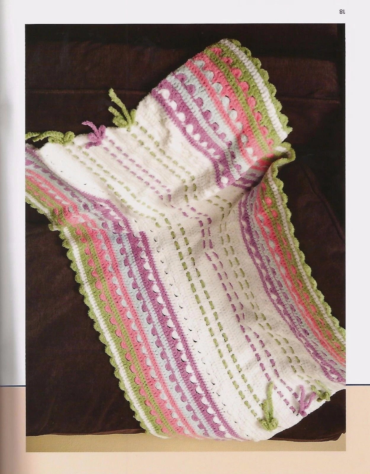 Knitted scarf with colorful pattern on a dark surface