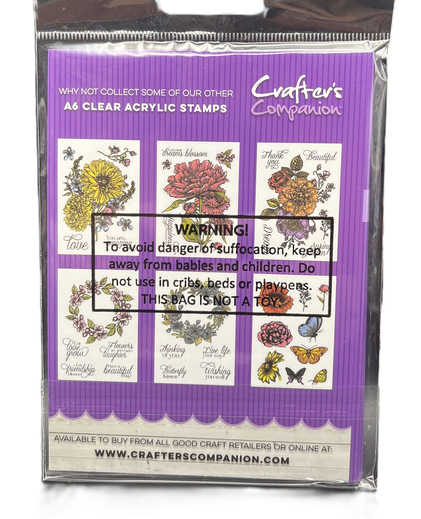 Packaged clear acrylic stamps with floral designs and warning label on purple background