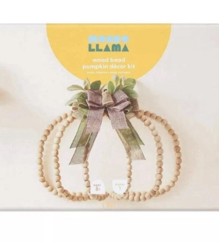 Wood bead pumpkin decor kit with a bow on a white background