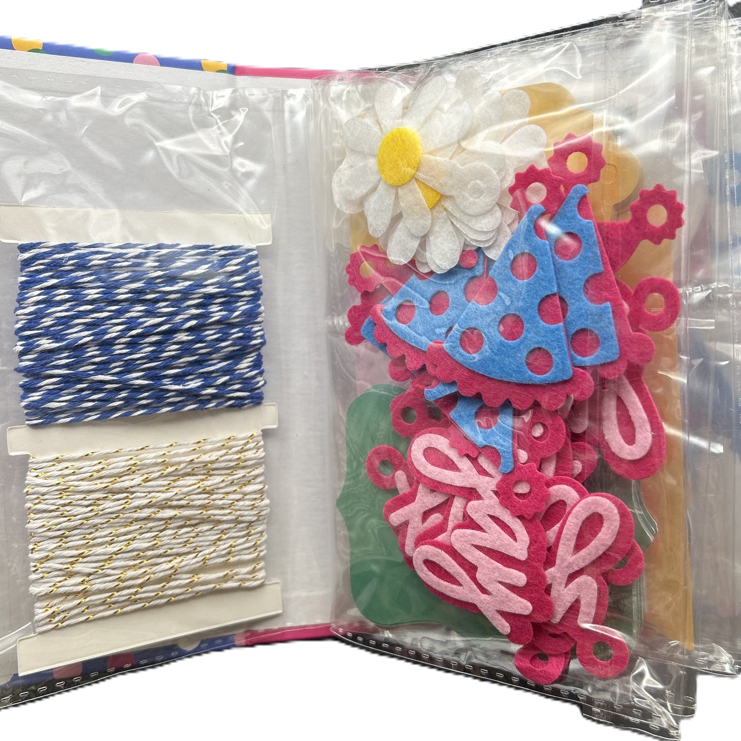 Decorative items including flowers, ribbons, and letters in a clear packaging bag.