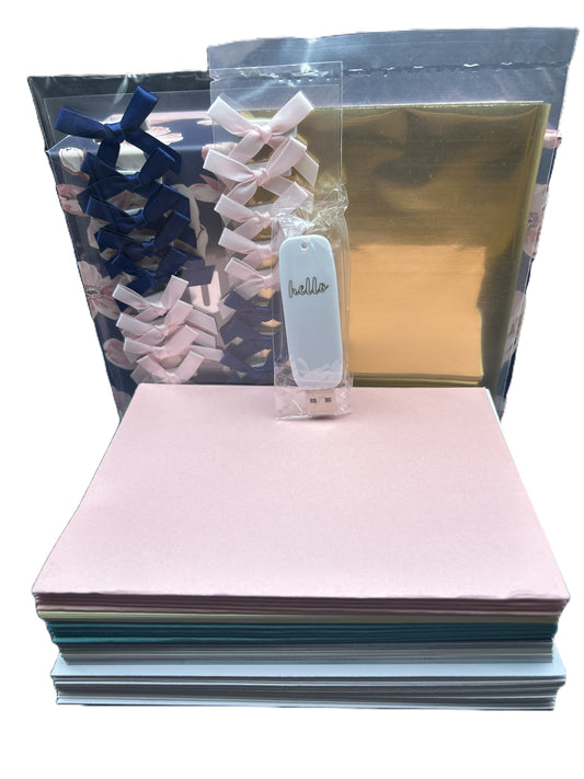 Stack of colorful paper sheets with a small bag of hair clips and a gold sheet in the background.