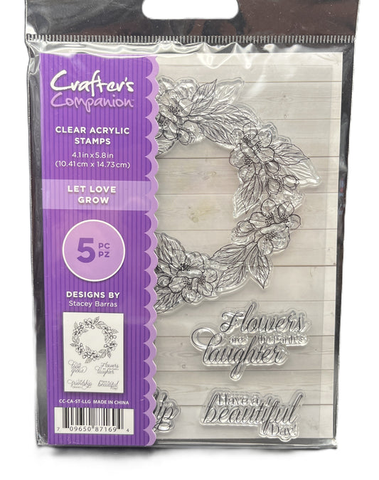 Clear acrylic stamps with floral design and text in packaging