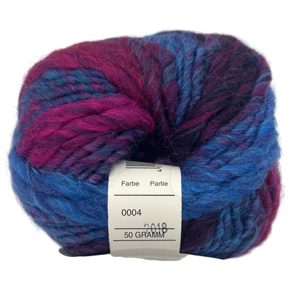 Ball of blue and purple yarn with a label on a white background