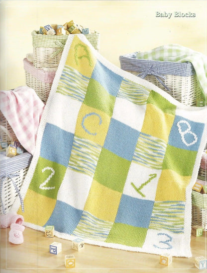 Baby blanket with alphabet and number patterns on a wooden floor.