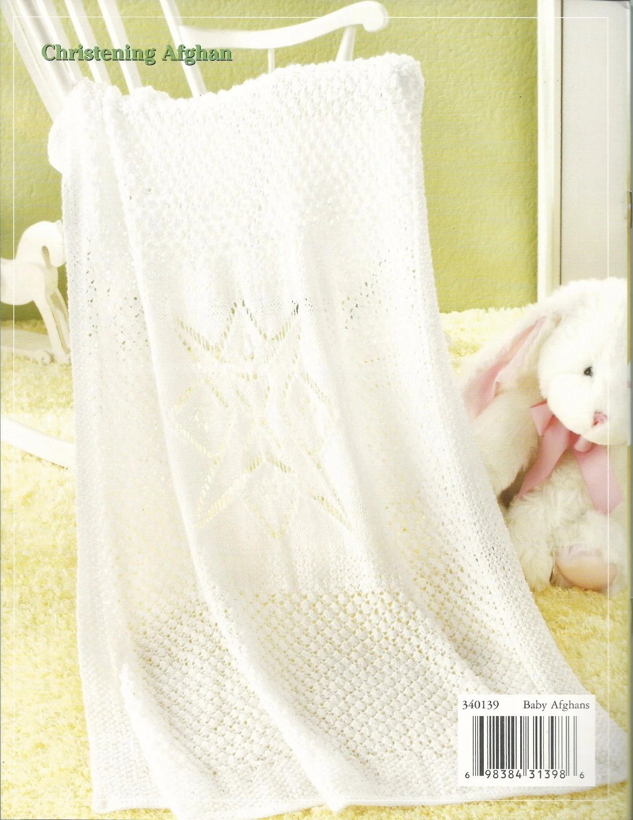 White baby blanket with a teddy bear on a yellow background